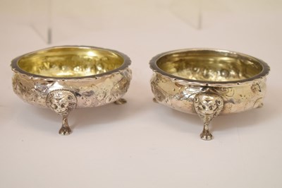 Lot 112 - Matched set of four silver salts each standing on three mask and paw feet