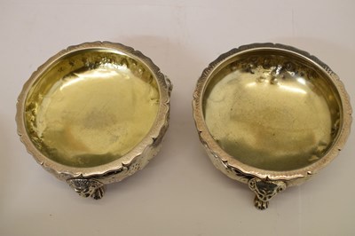 Lot 112 - Matched set of four silver salts each standing on three mask and paw feet