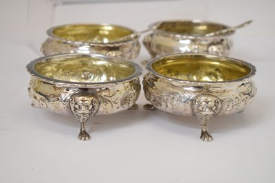 Lot 112 - Matched set of four silver salts each standing on three mask and paw feet