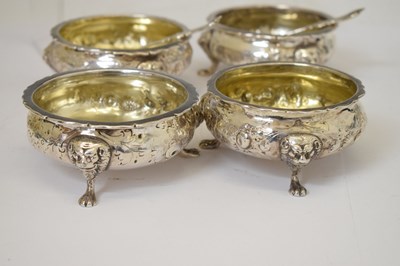 Lot 112 - Matched set of four silver salts each standing on three mask and paw feet