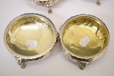 Lot 112 - Matched set of four silver salts each standing on three mask and paw feet