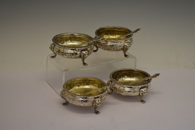 Lot 112 - Matched set of four silver salts each standing on three mask and paw feet