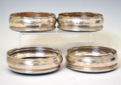 Lot 181 - Four Elizabeth II silver-mounted wine coasters