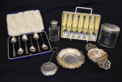 Lot 213 - Two sets of silver teaspoons, an Elizabeth II silver tea strainer and stand, etc