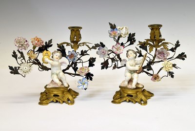 Lot 235 - Pair of late 19th century Continenal gilt metal and porcelain mounted figural candlesticks