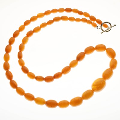 Lot 103 - Graduated string of oval amber beads