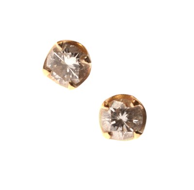 Lot 180 - Pair of diamond single stone yellow metal stud earrings