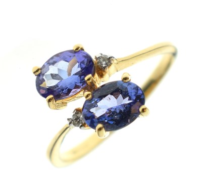 Lot 29 - Two-stone tanzanite and diamond 18ct gold crossover dress ring