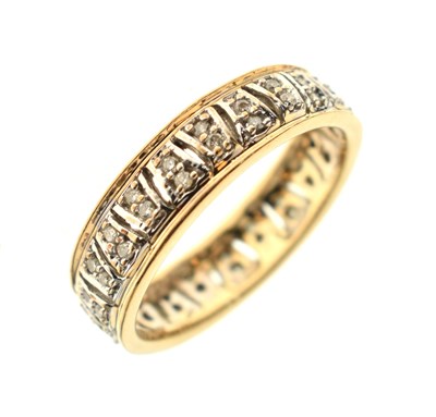 Lot 23 - 9ct yellow and white gold diamond set band