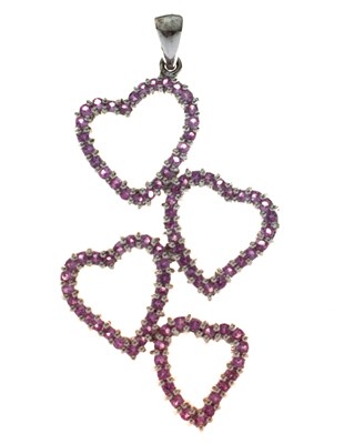 Lot 128 - 9ct white gold and pink sapphire pendant with four hearts