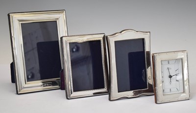 Lot 277 - Three Elizabeth II silver mounted easel photograph frames and desk clock