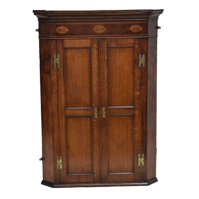 Lot 641 - George III inlaid oak corner cupboard