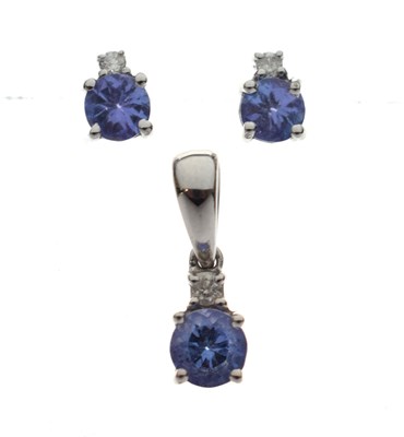 Lot 135 - 14ct white gold, tanzanite and diamond pendant and matching ear studs