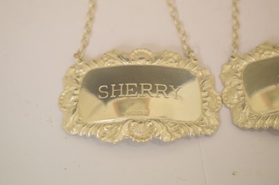 Lot 161 - George V silver toast rack, a set of three Elizabeth II silver decanter labels, etc