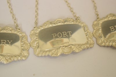 Lot 161 - George V silver toast rack, a set of three Elizabeth II silver decanter labels, etc