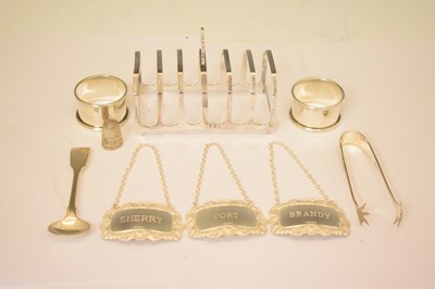 Lot 161 - George V silver toast rack, a set of three Elizabeth II silver decanter labels, etc