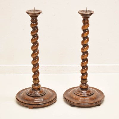 Lot 626 - Pair of reproduction walnut barley twist floor standing picket candlesticks