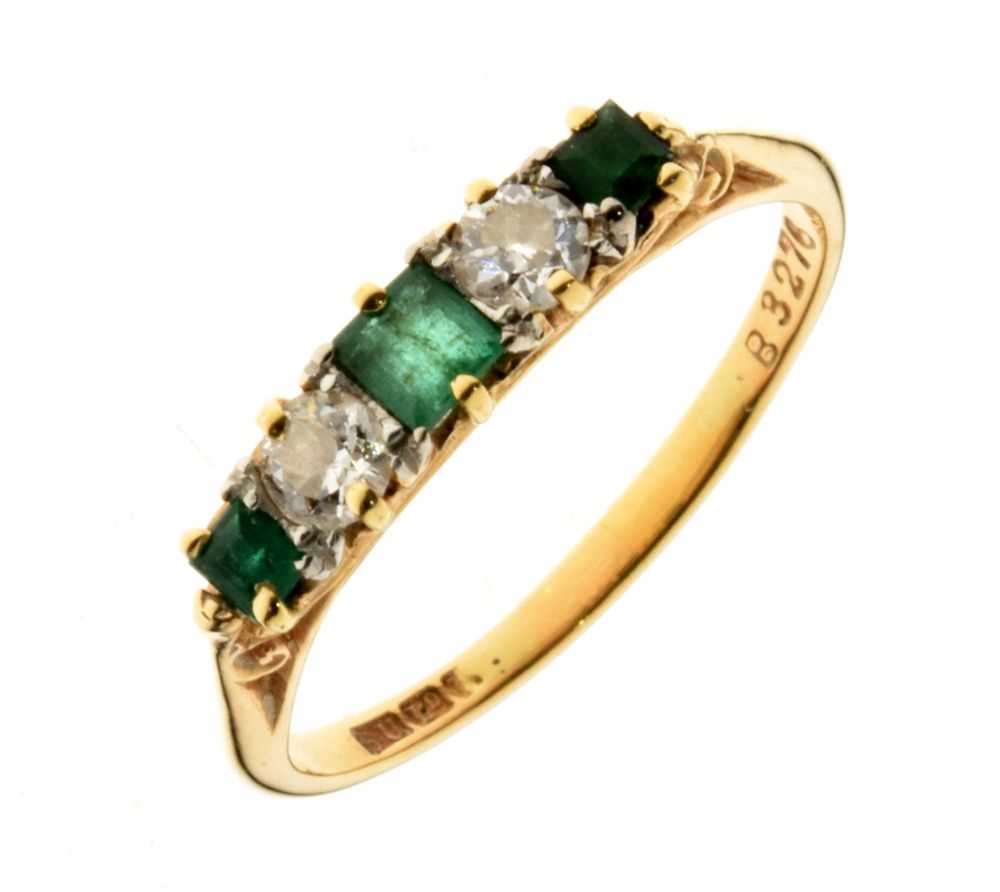 Lot 21 - Five-stone diamond and emerald ring