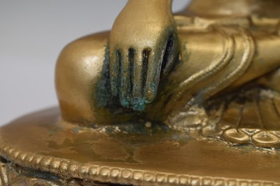 Lot 565 - Himalayan gilt alloy figure of Buddha Shakyamuni