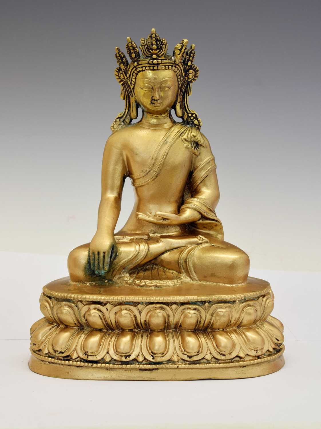 Lot 565 - Himalayan gilt alloy figure of Buddha Shakyamuni