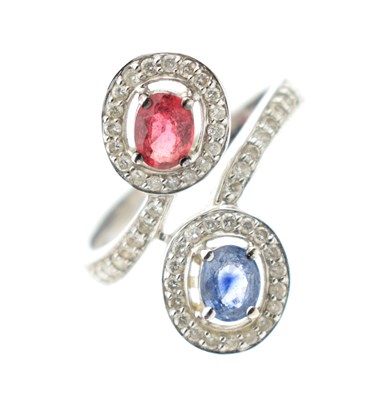 Lot 14 - 18ct white gold ruby, sapphire and diamond crossover dress ring