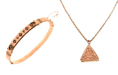 Lot 74 - Edwardian 9ct rose gold hinged bangle and a triangular locket on 9ct chain