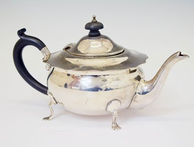 Lot 138 - George V silver teapot standing on four cast feet