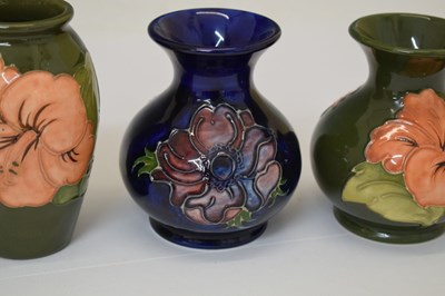 Lot 364 - Moorcroft pottery - An 'Anemone' ovoid vase, two 'Hibiscus' pattern, and a 'Bermuda Lily' vase