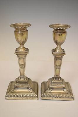 Lot 159 - Pair of silver candlesticks in the neoclassical taste of square columner form