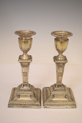 Lot 159 - Pair of silver candlesticks in the neoclassical taste of square columner form