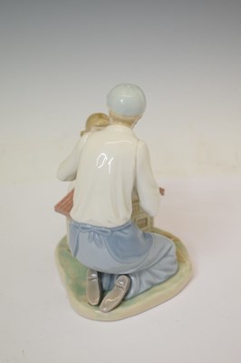 Lot 653 - Lladro - Porcelain figure group, 'A New Dolls House', 5139
