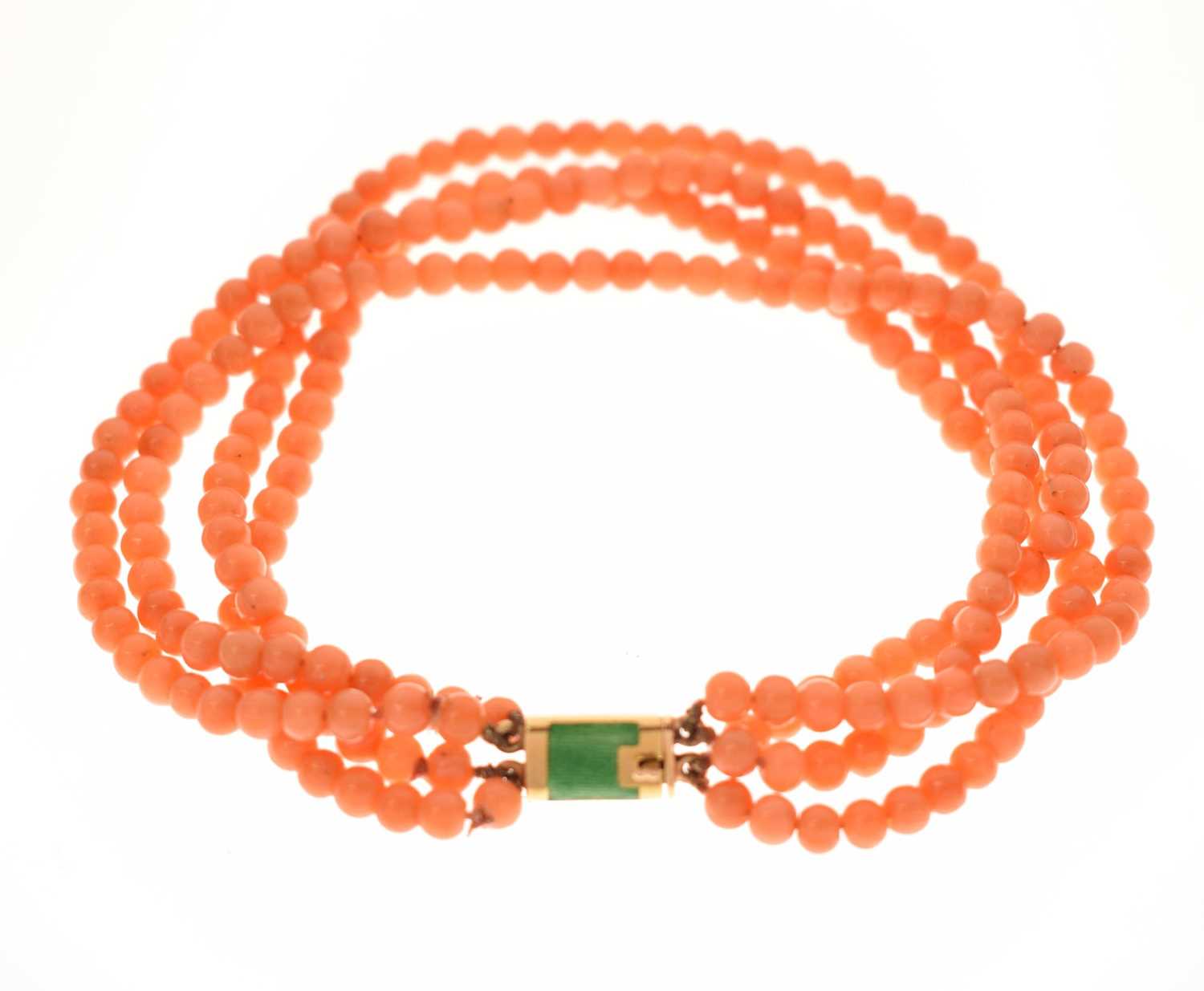 Lot 180 - Coral four-strand bracelet with French gold and green enamel clasp