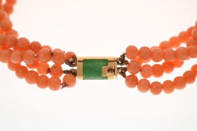 Lot 180 - Coral four-strand bracelet with French gold and green enamel clasp
