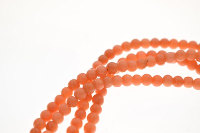 Lot 180 - Coral four-strand bracelet with French gold and green enamel clasp