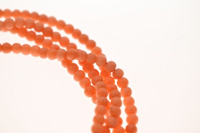 Lot 180 - Coral four-strand bracelet with French gold and green enamel clasp