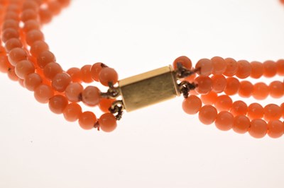 Lot 180 - Coral four-strand bracelet with French gold and green enamel clasp