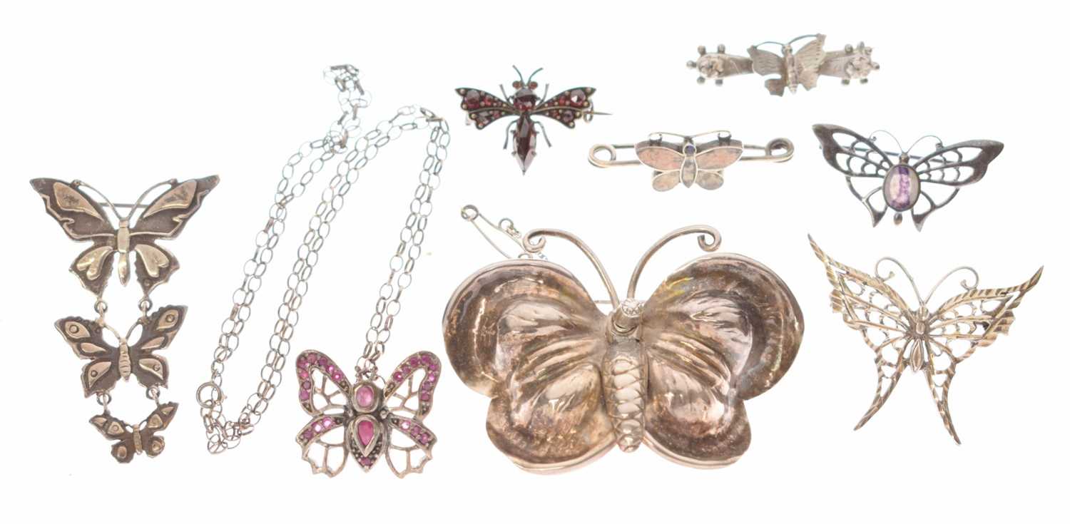 Lot 101 - Collection of seven butterfly brooches and a ruby set butterfly pendant necklace