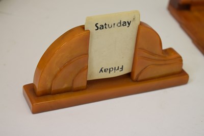 Lot 361 - Art Deco amber bakelite desk accessories