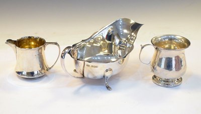 Lot 152 - George V silver sauce boat, an Edward VII silver cream jug, and a George V silver christening mug