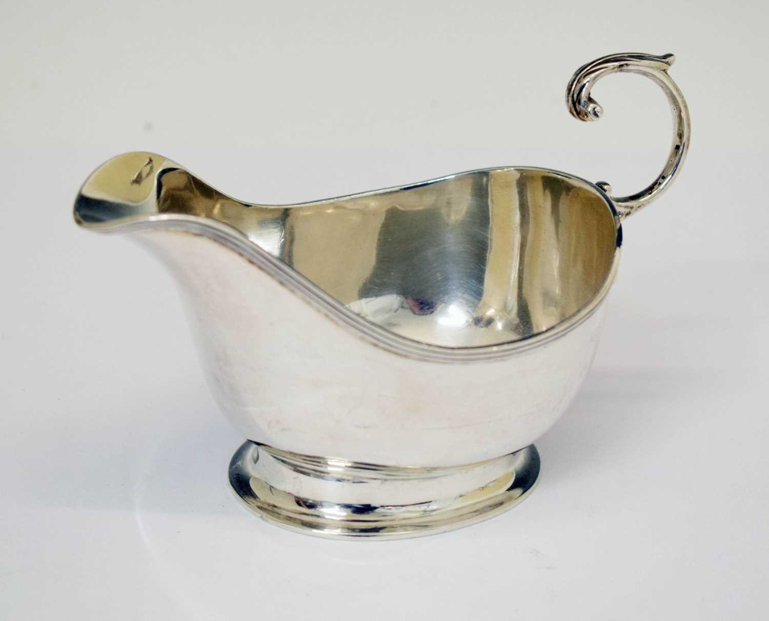 Lot 304 - George VI silver sauce boat with flying scroll handle