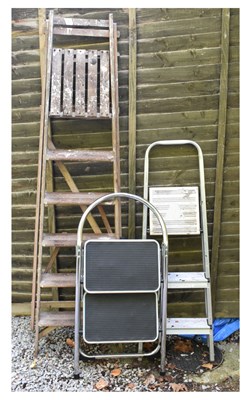 Lot 555 - Three step ladders, one wooden