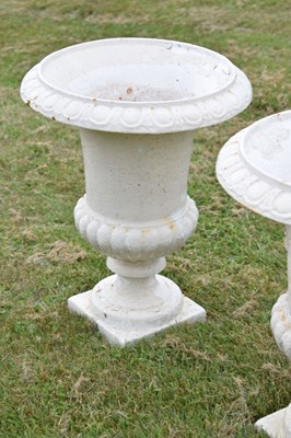 Lot 210 - Pair of white-painted cast iron garden urns