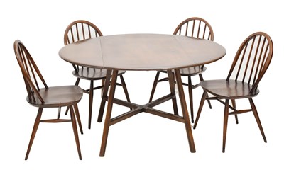 Lot 552 - Ercol - Dark elm drop leaf dining table four chairs