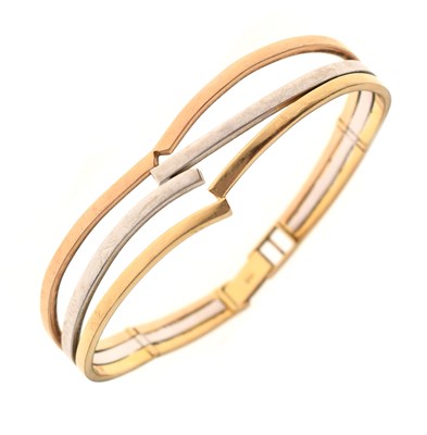 Lot 111 - Tri-colour metal bangle, stamped 585