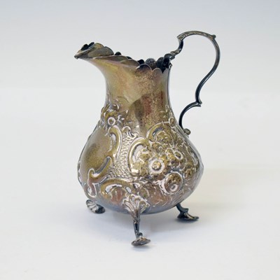 Lot 167 - London silver jug with foliate design raised on three shell feet