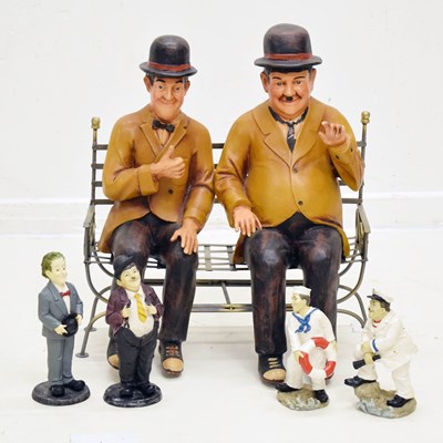 Lot 331 - Large figures of Stan Laurel and Oliver Hardy seated on a metal park bench, etc