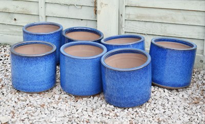 Lot 556 - Group of seven blue glazed cylindrical garden planters