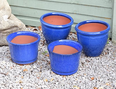 Lot 557 - Two pairs of blue glazed garden pots/planters
