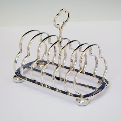 Lot 196 - Victorian silver toast rack raised on four bun feet