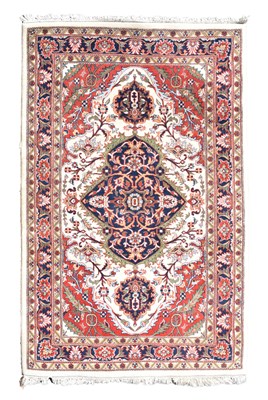 Lot 517 - Machine made cream and red ground wool rug